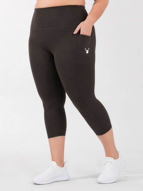 Leera dark brown plus size capri pocket legging front view with white sneakers