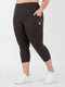 Leera dark brown plus size capri pocket legging front view with white sneakers