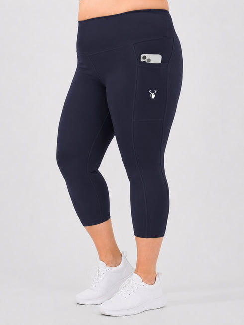 Leera navy blue plus size capri pocket legging side view with white sneakers