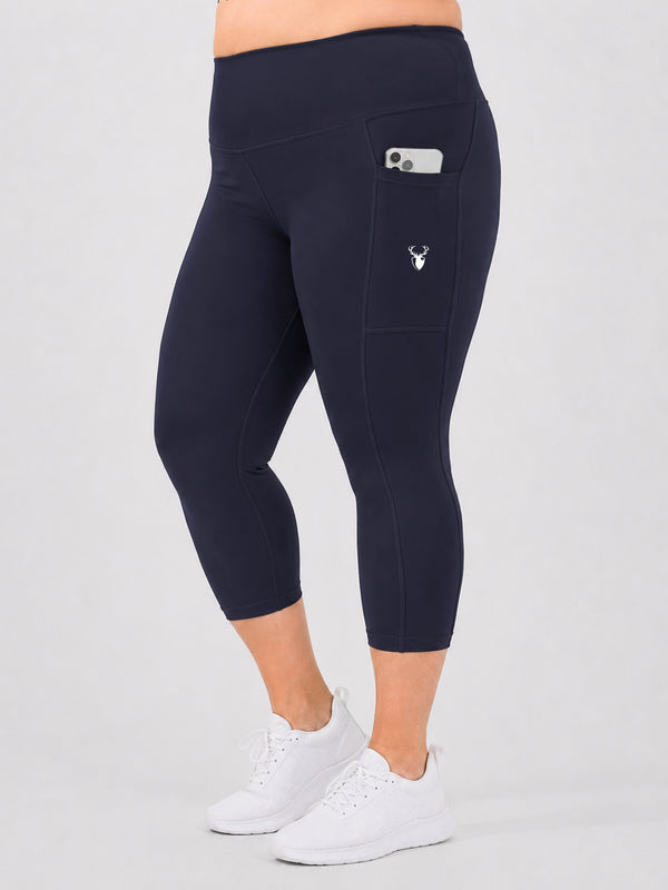 Leera navy blue plus size capri pocket legging side view with white sneakers